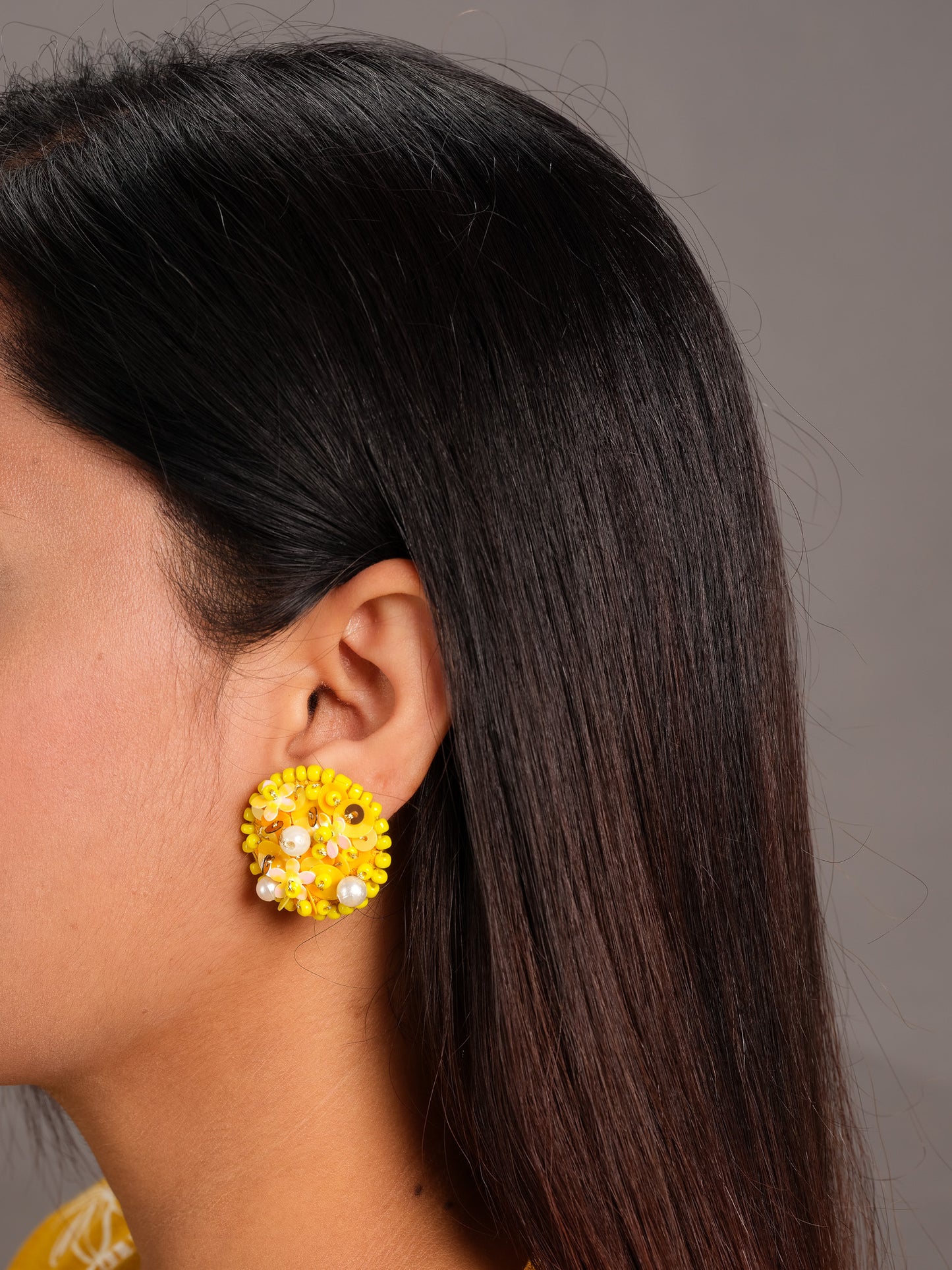 Close-up of marigold embroidered earrings showing detailed sequin and threadwork - handmade statement earrings