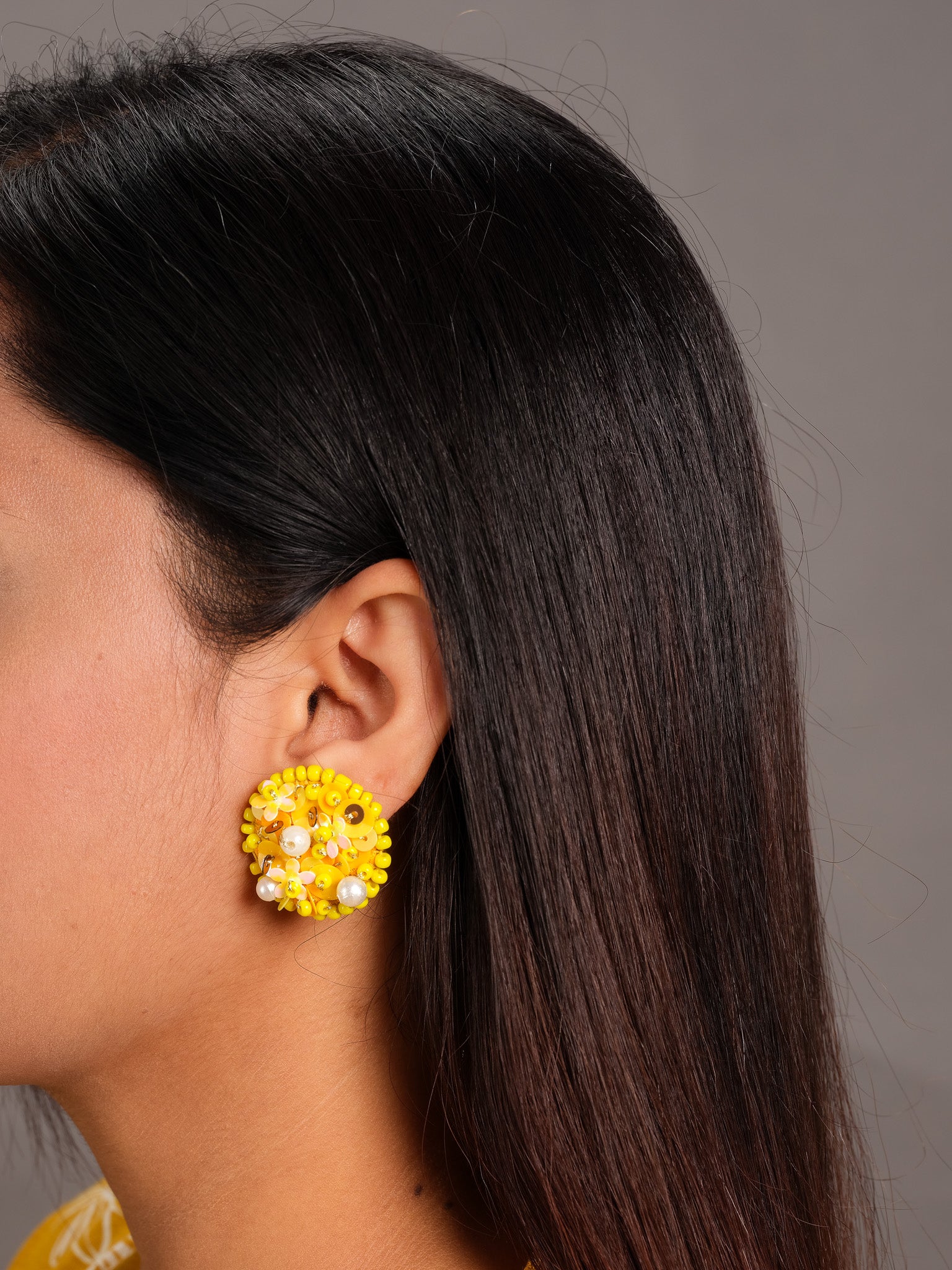 Close-up of marigold embroidered earrings showing detailed sequin and threadwork - handmade statement earrings