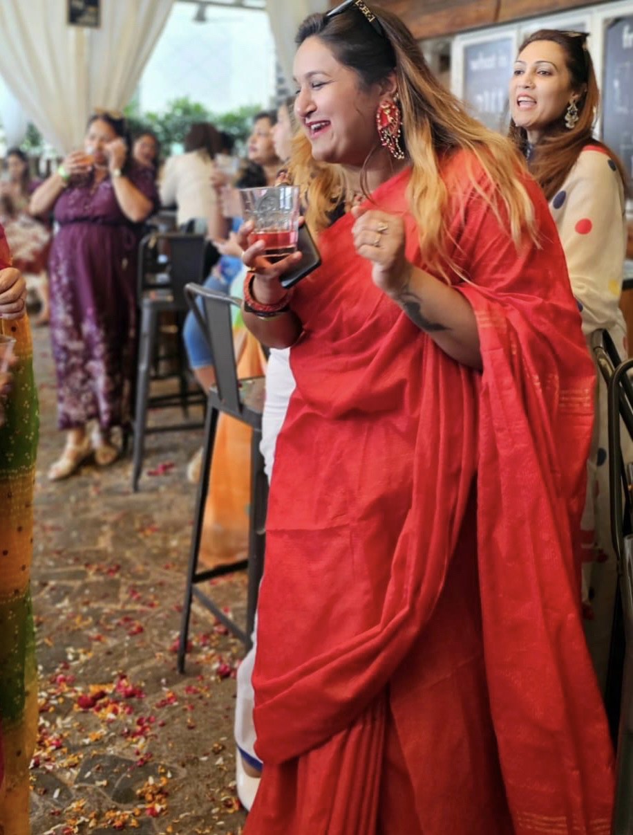 Woman wearing Parna red statement earrings - handmade ethnic jewelry for weddings and festive occasions